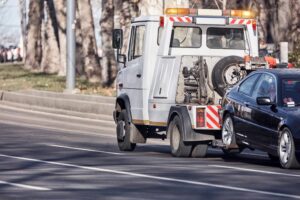 tow truck carrying improperly parked car or repossessed vehicle